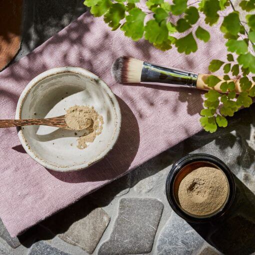 flat lay of face mask mix. Wooden spoon, brush and bowl included.